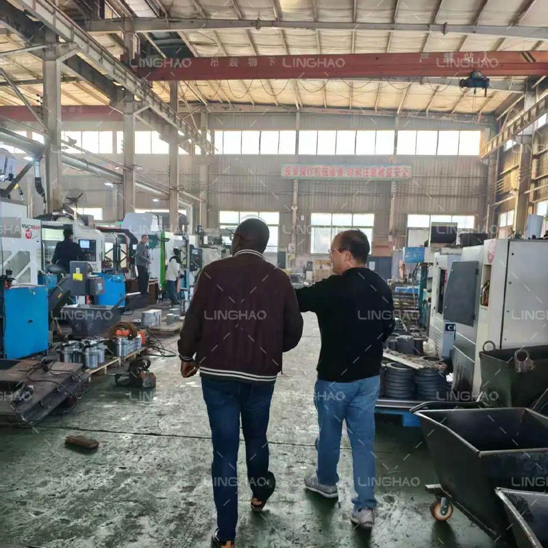 Customer delegation touring the concrete machinery production line with Linghon sales and engineering staff