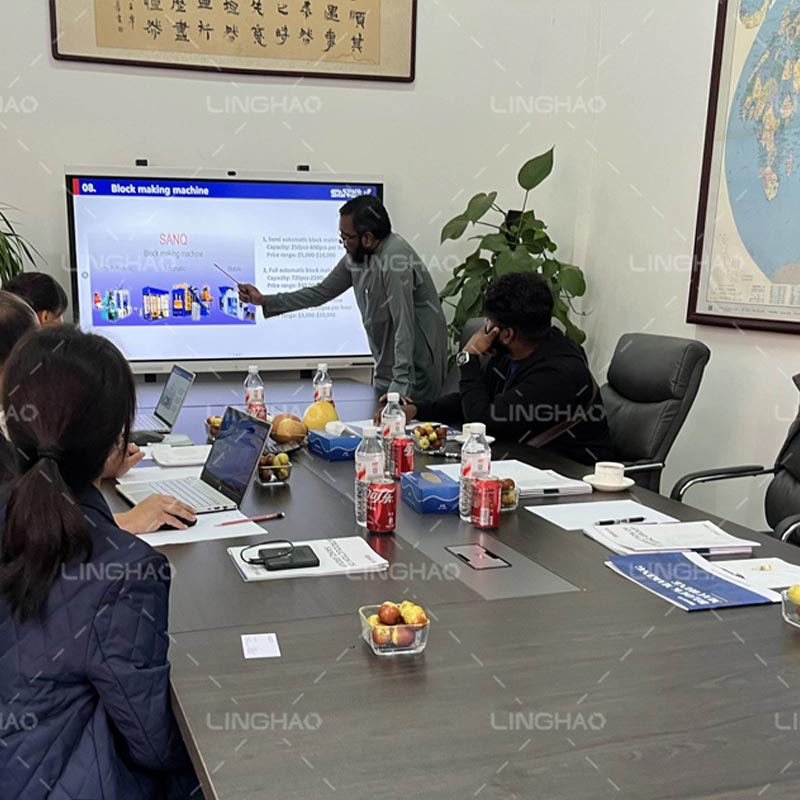 Customer inspecting the assembly and quality control process of automatic brick machines at SanqGroup factory