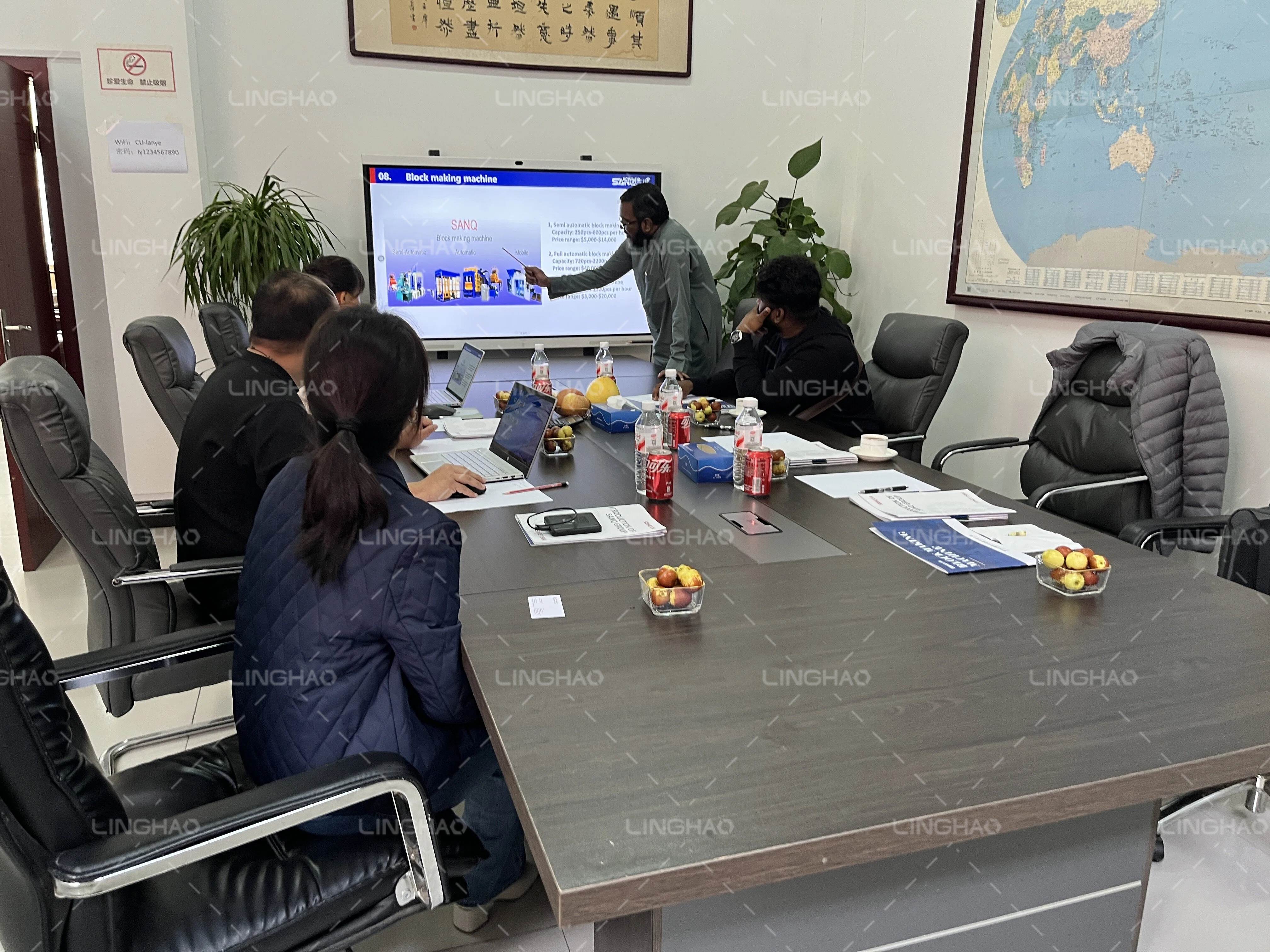 Customer inspecting the assembly and quality control process of automatic brick machines at SanqGroup factory